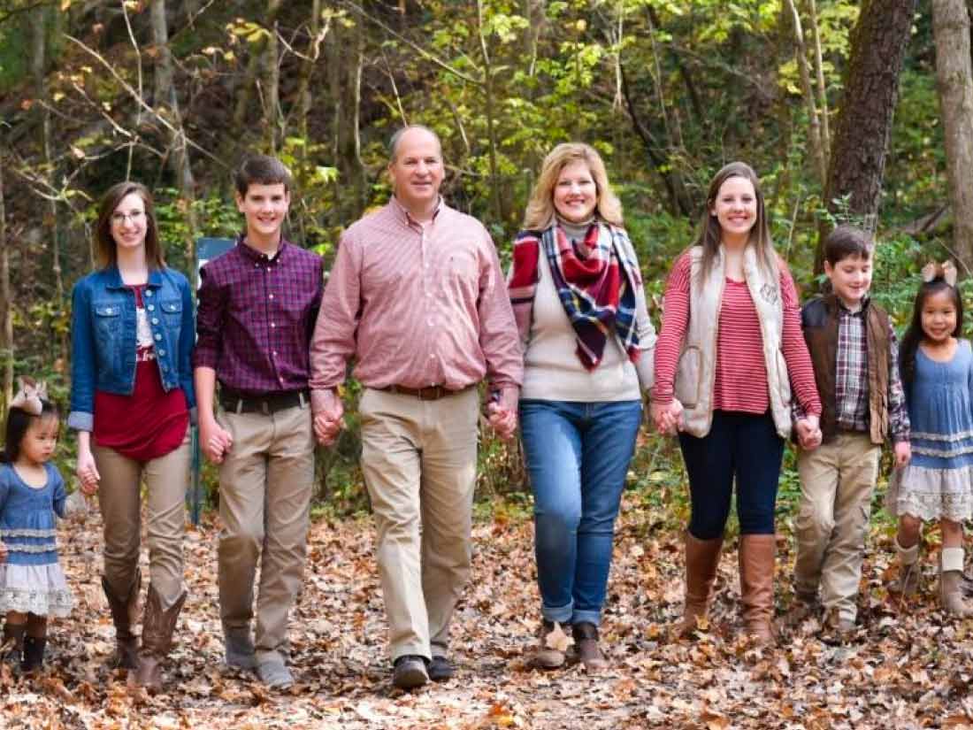 Happy adoptive family walking together